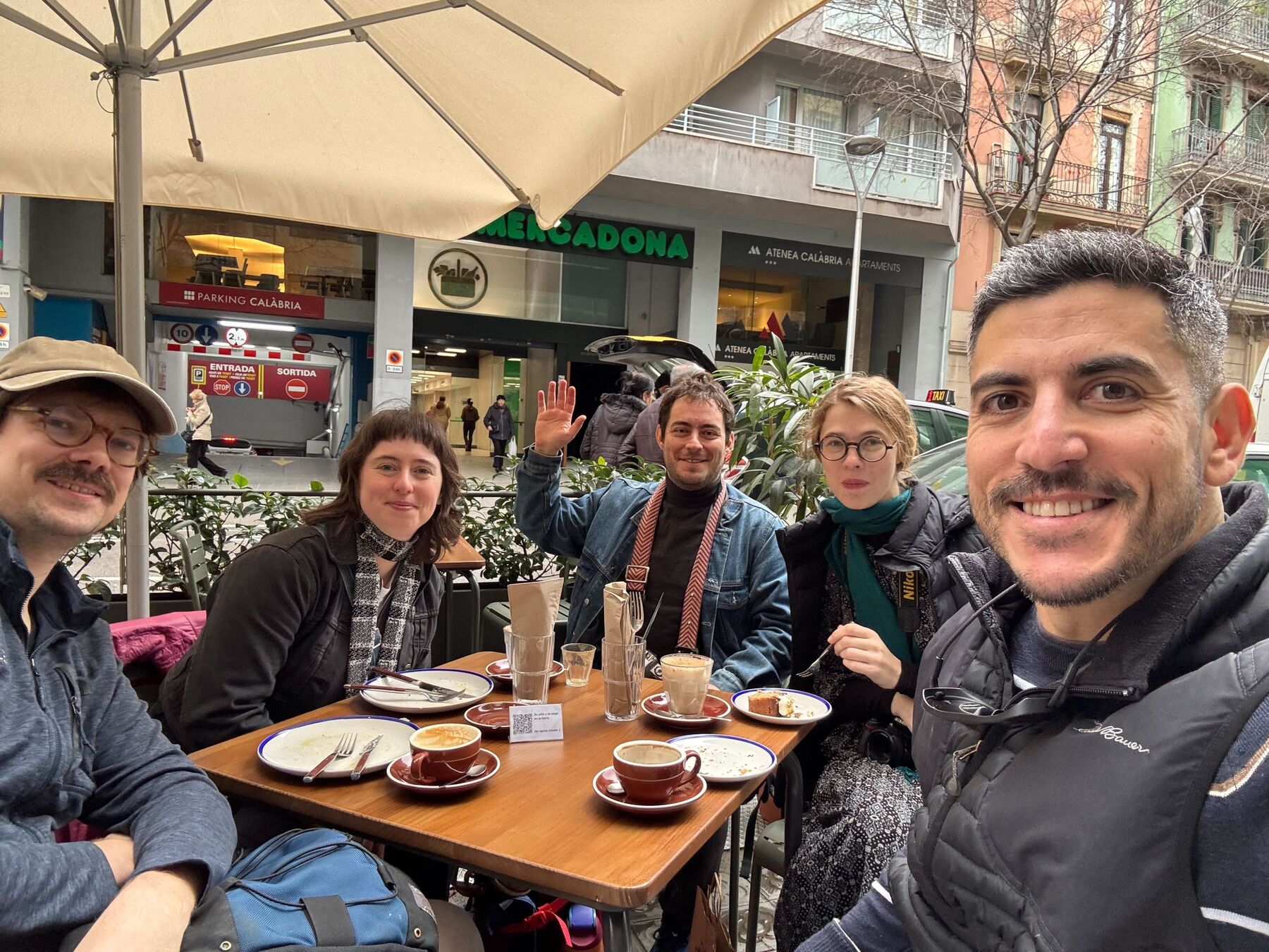 Five members of the engineering team at an outdoor café table in Barcelona