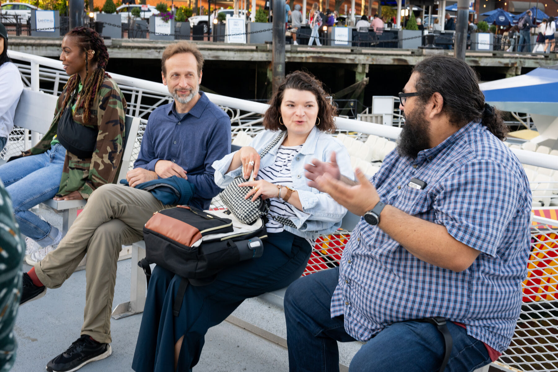 Teammates deep in conversation on a boat deck
