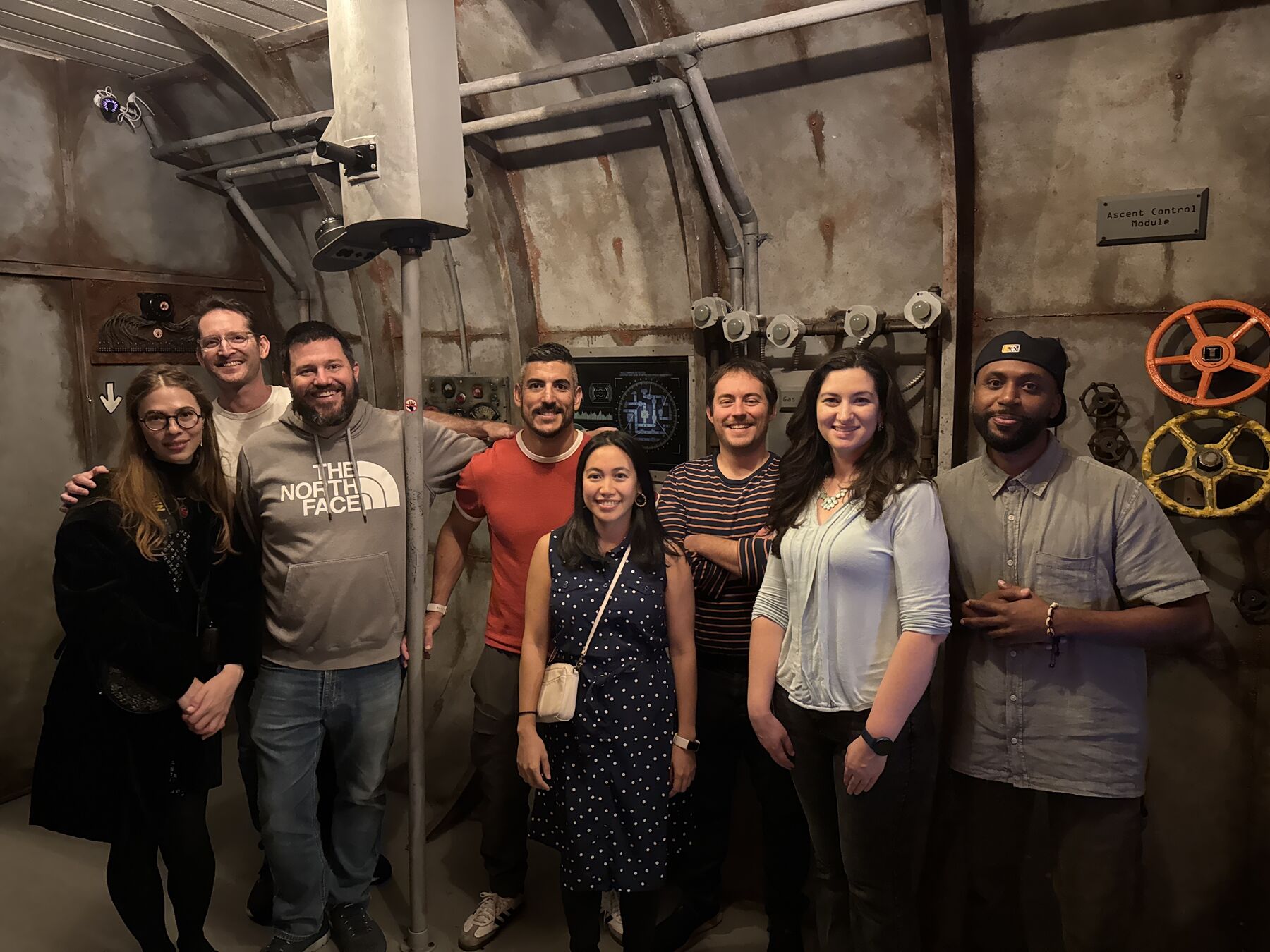 Teammates posing together in an escape room