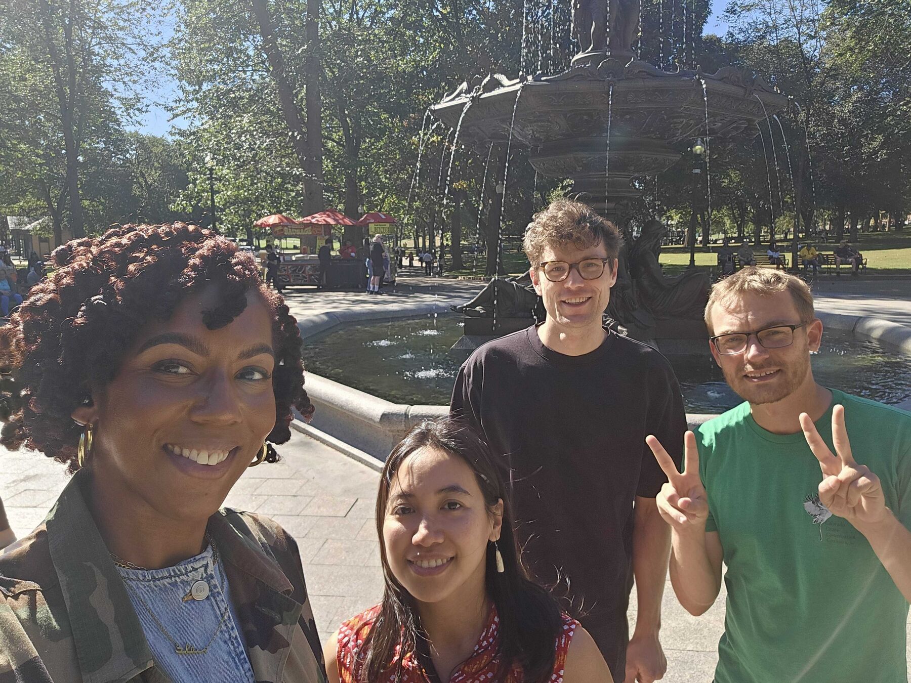 Four teammates taking a selfie in front of a fountain