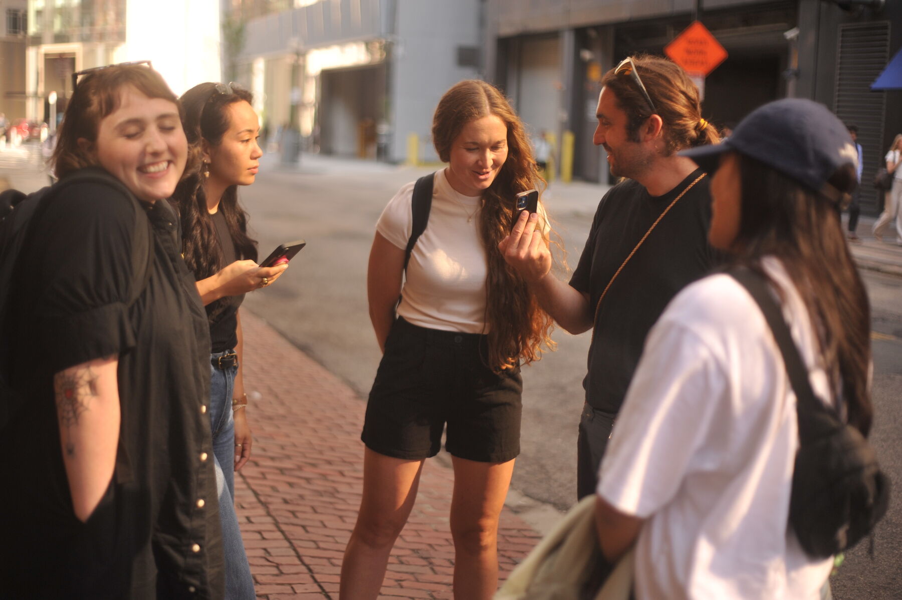 Teammates chatting on a downtown sidewalk
